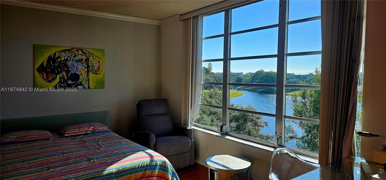 3100 North Course Lane, Unit 502 Pompano Beach, FL 33069 - Photo 3 of 32 a bedroom with a bed and a painting on the wall