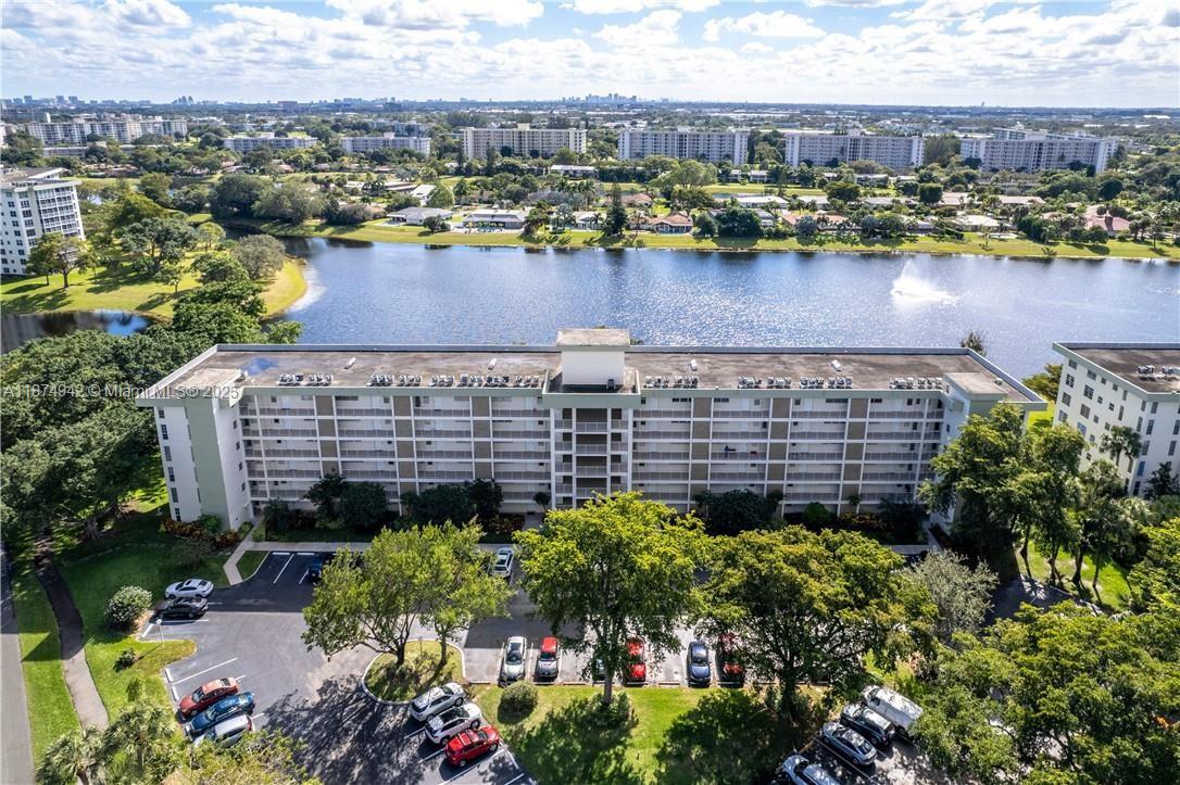 3100 North Course Lane, Unit 502 Pompano Beach, FL 33069 - Photo 6 of 32 a view of a lake with a building in the background