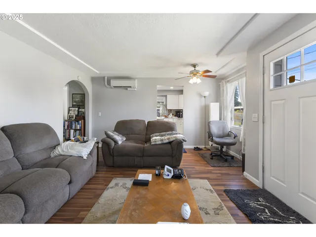 a kitchen with a refrigerator and white cabinets