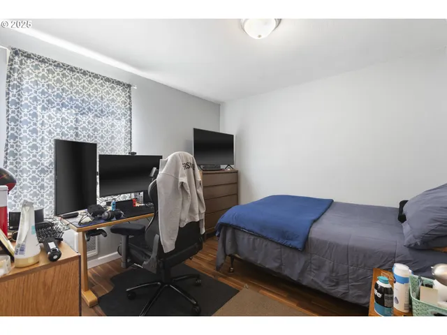 a bedroom with a bed and a mirror