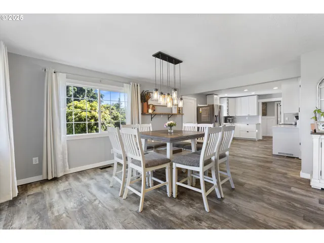 a kitchen with stainless steel appliances refrigerator sink cabinets and wooden floor
