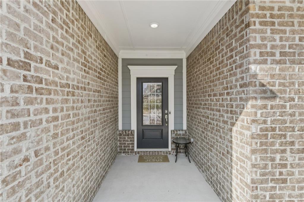 567 Barlow Place Grayson, GA 30017 - Photo 11 of 65 a view of a bathroom with brick wall and a shower