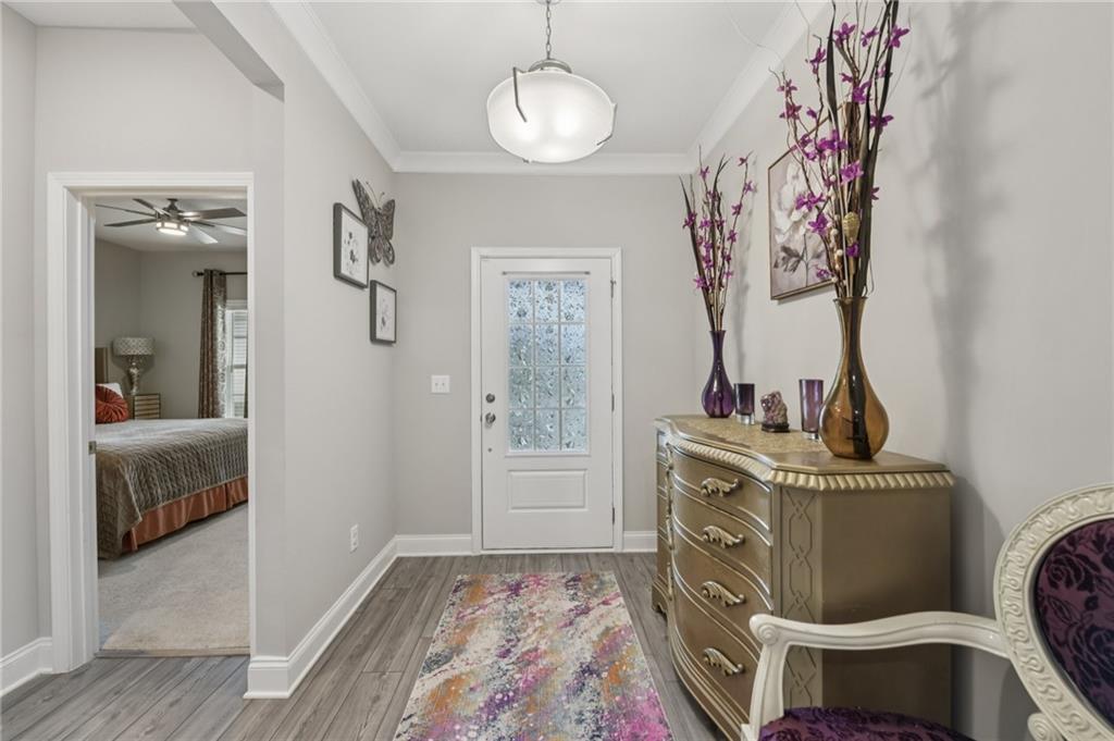 567 Barlow Place Grayson, GA 30017 - Photo 12 of 65 a view of a bedroom with a bed and wooden floor