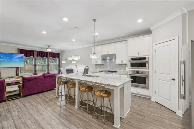 a living room with furniture fireplace and a large window