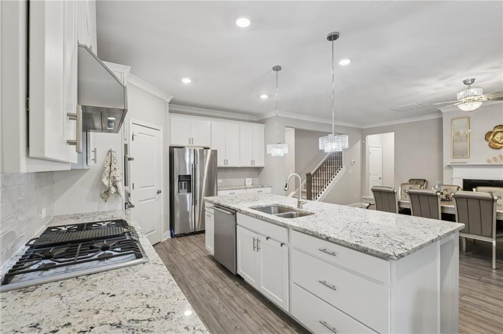 567 Barlow Place Grayson, GA 30017 - Photo 18 of 65 a kitchen with stainless steel appliances granite countertop a sink stove and refrigerator