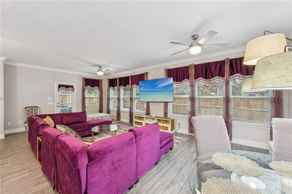 567 Barlow Place Grayson, GA 30017 - Photo 20 of 65 a living room with furniture fireplace and a large window