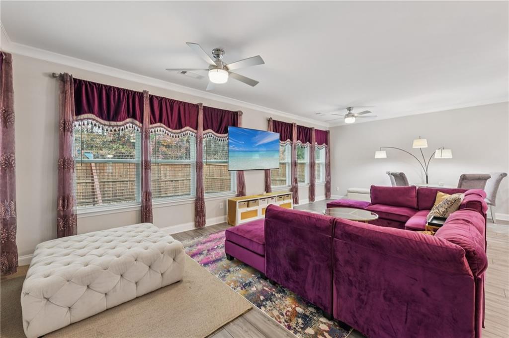567 Barlow Place Grayson, GA 30017 - Photo 21 of 65 a living room with furniture and a large window
