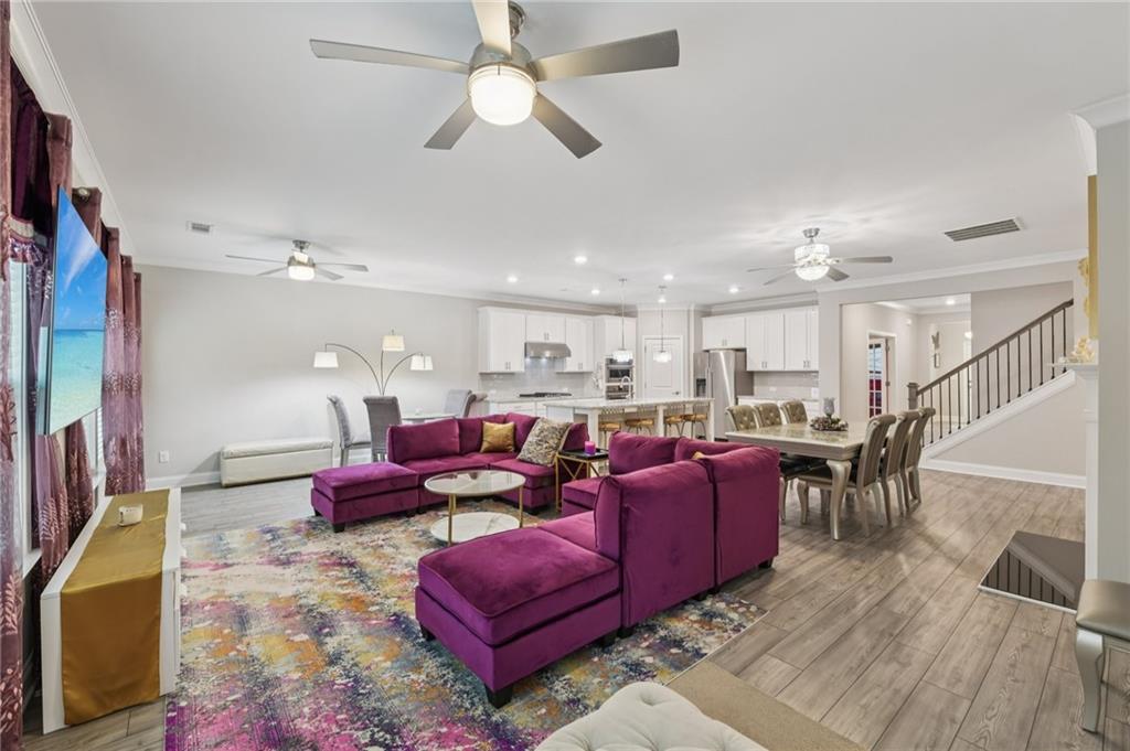 567 Barlow Place Grayson, GA 30017 - Photo 22 of 65 a living room with lots of furniture kitchen view and a chandelier