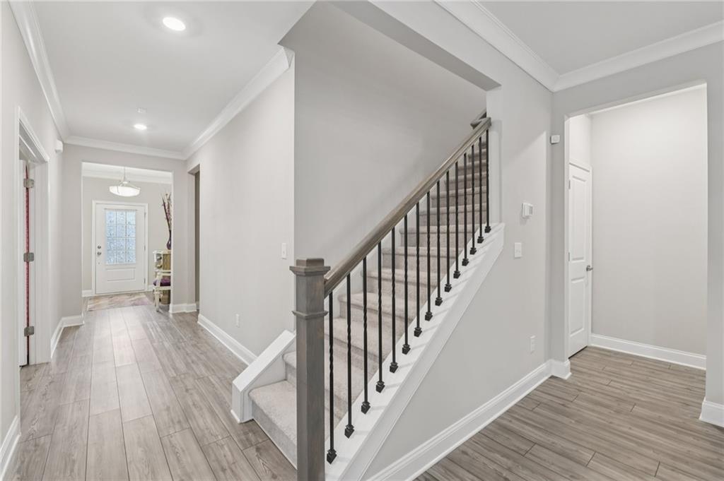 567 Barlow Place Grayson, GA 30017 - Photo 33 of 65 a view of a hallway with wooden floor and staircase