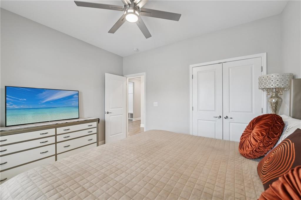 567 Barlow Place Grayson, GA 30017 - Photo 34 of 65 a bedroom with a bed and a flat screen tv