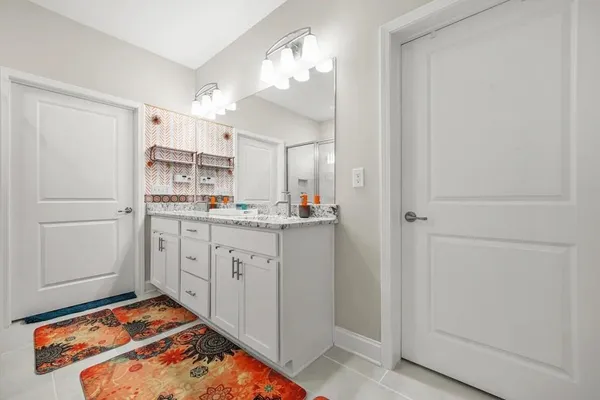 a view of walk in closet with clothes