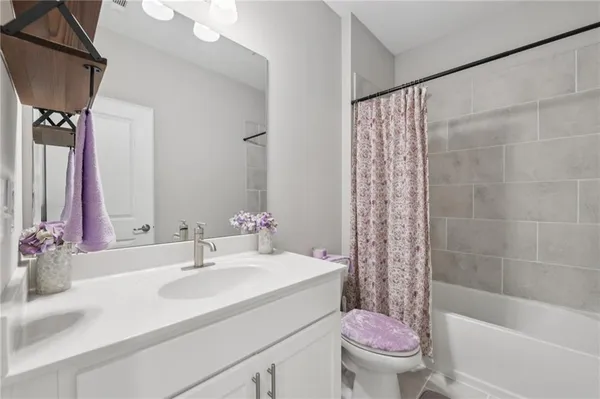 a bedroom with a bed and a ceiling fan