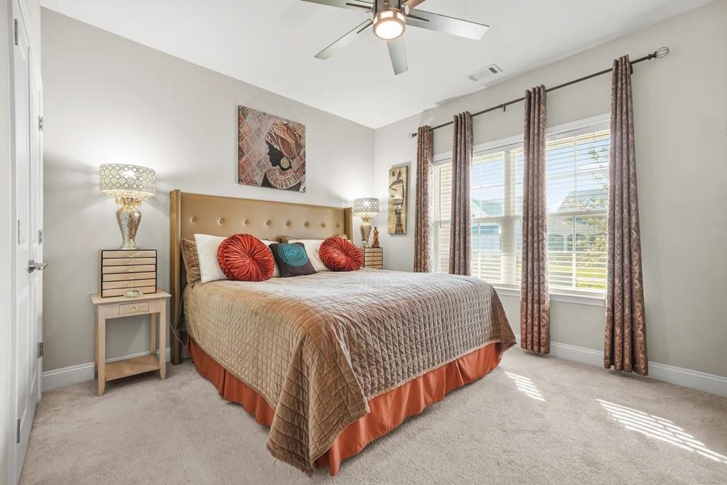 567 Barlow Place Grayson, GA 30017 - Photo 46 of 65 a bedroom with a bed and a chandelier