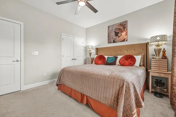 a bedroom with a bed and a dresser in it