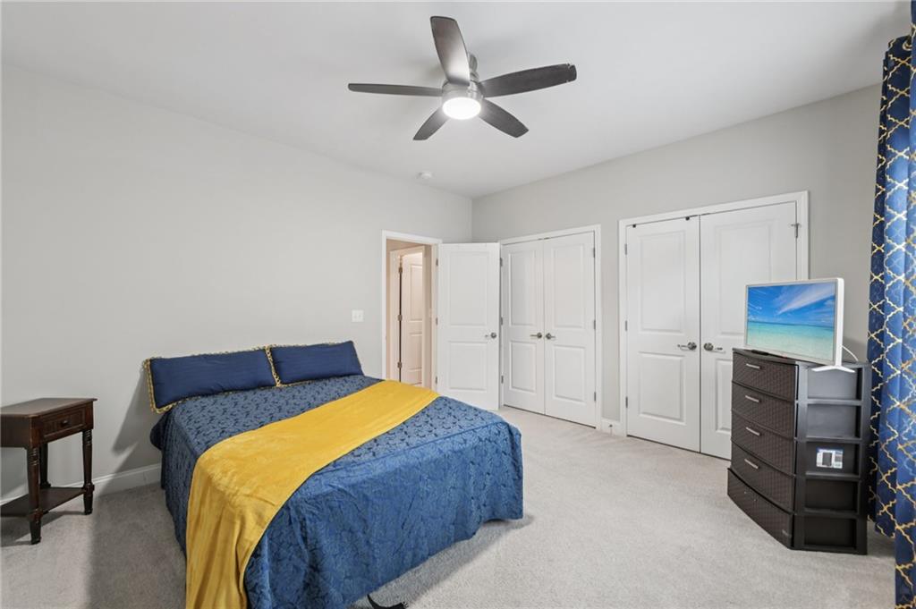 567 Barlow Place Grayson, GA 30017 - Photo 50 of 65 a bedroom with a bed and a ceiling fan