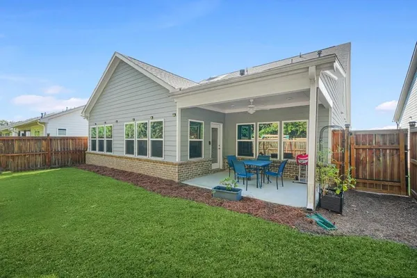 a view of a backyard with a slide trees and wooden fence