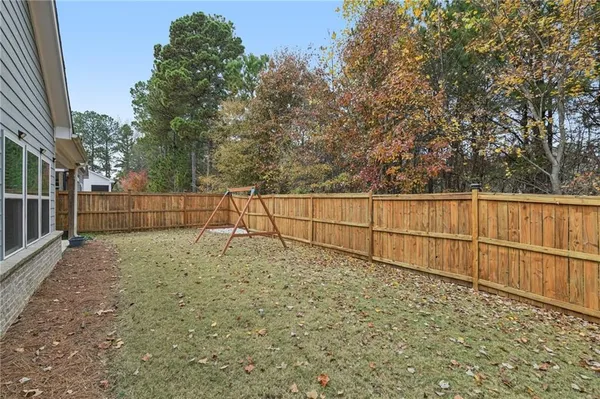 a view of a patio with a table chairs and a yard
