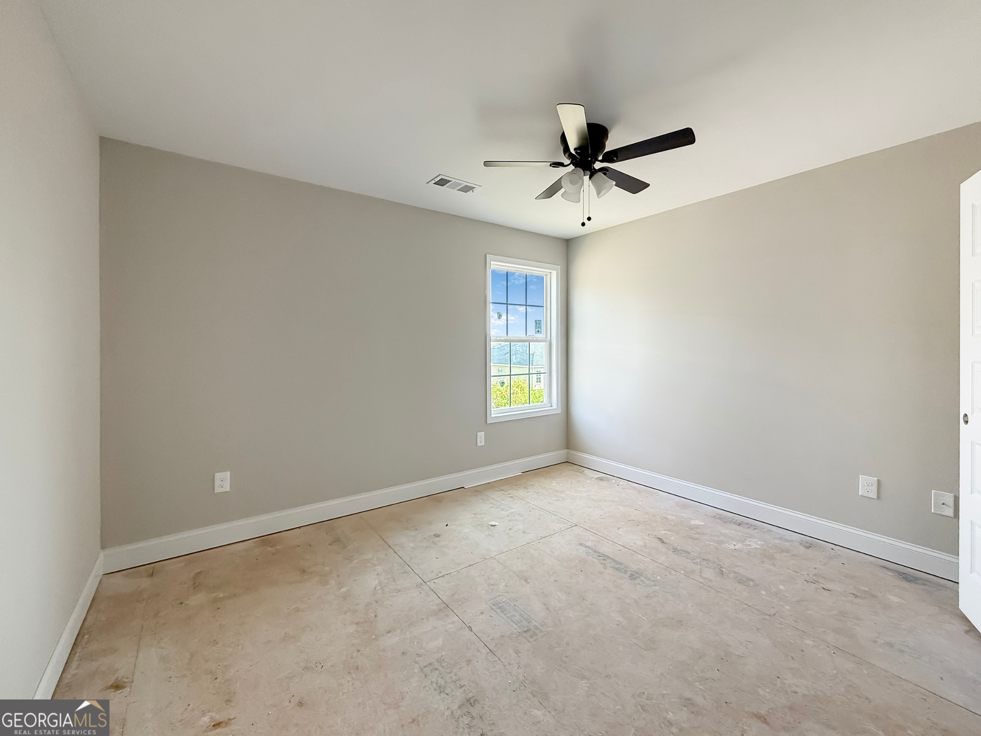 206 Sutton Drive Perry, GA 31069 - Photo 16 of 27 an empty room with windows and fan
