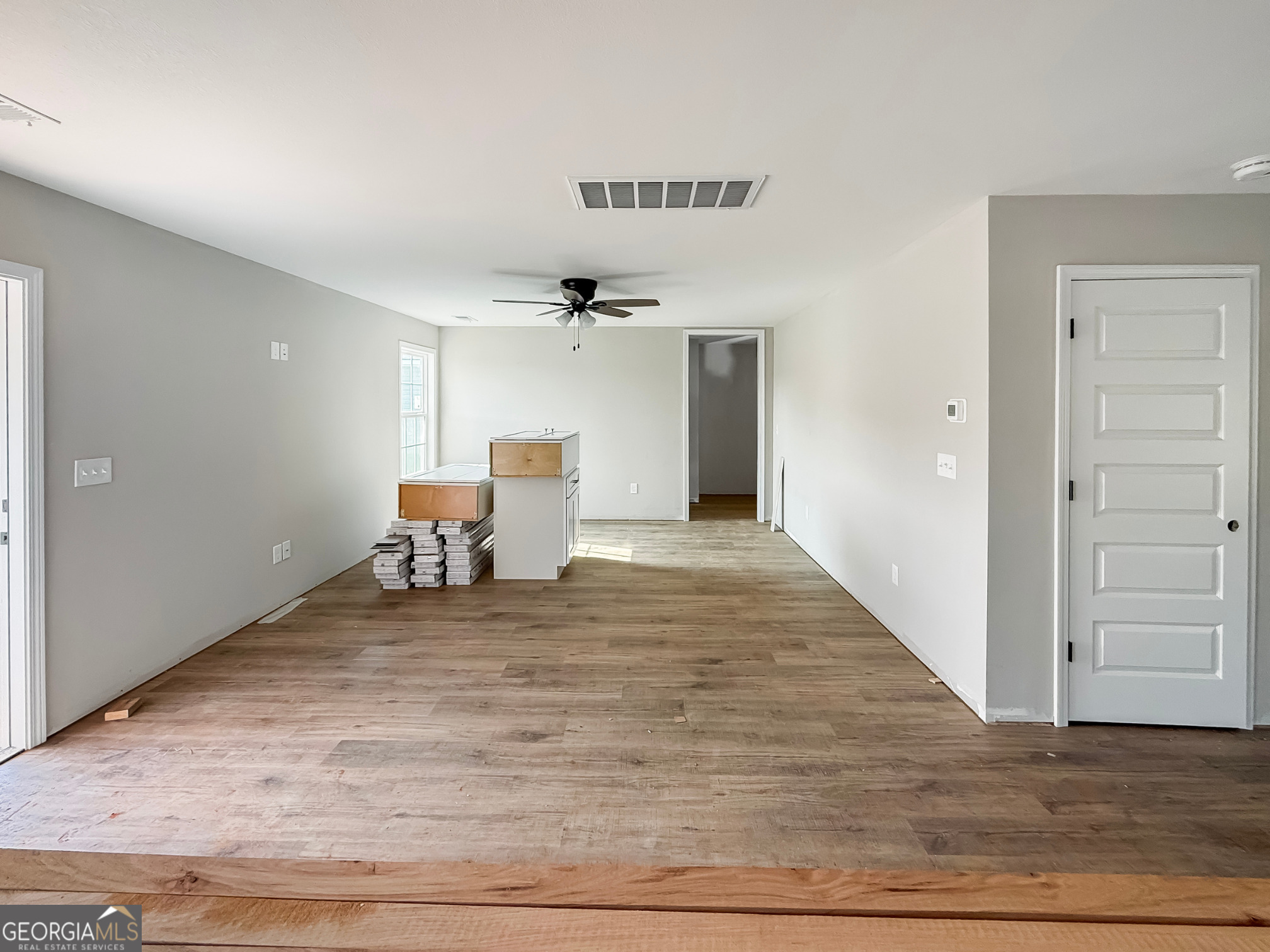 206 Sutton Drive Perry, GA 31069 - Photo 8 of 27 a view of a livingroom with wooden floor furniture and windows