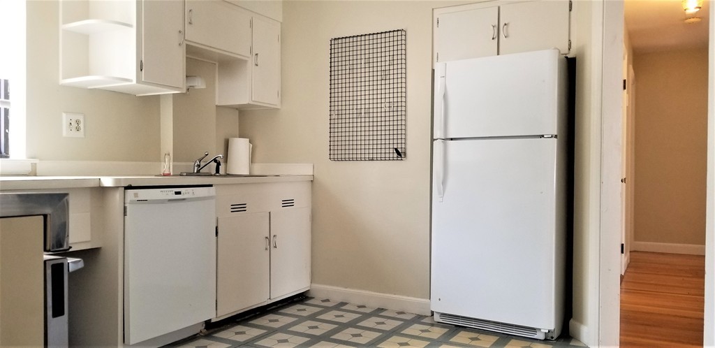14 Ashland Street, Unit 2R Worcester, MA 01609 - Photo 15 of 16 a utility room with cabinets washer and dryer