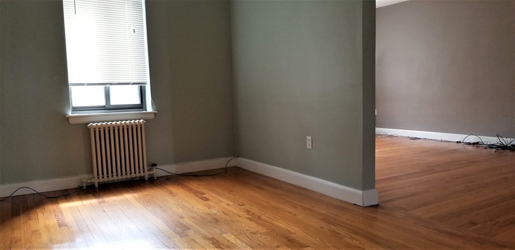 14 Ashland Street, Unit 2R Worcester, MA 01609 - Photo 7 of 16 an empty room with wooden floor