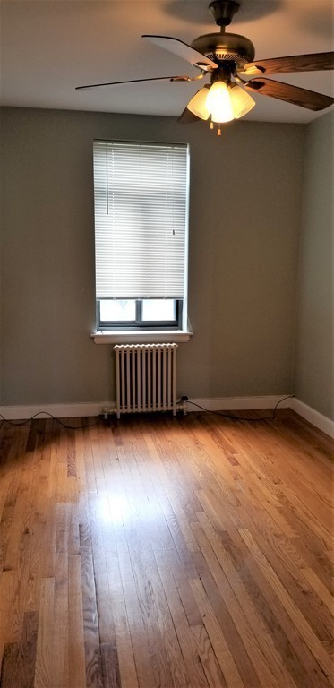 14 Ashland Street, Unit 2R Worcester, MA 01609 - Photo 8 of 16 a view of an empty room with wooden floor and a window