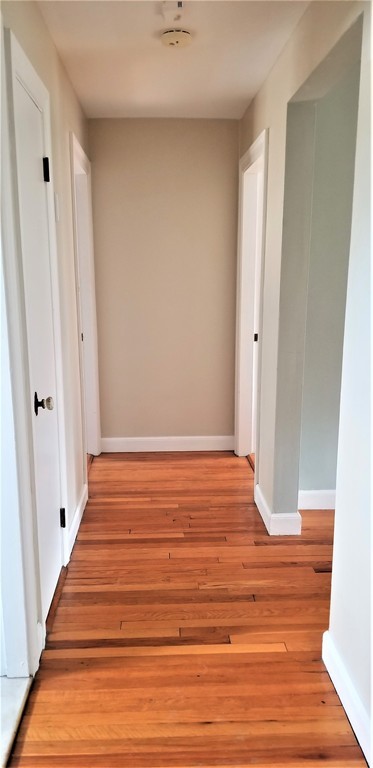 14 Ashland Street, Unit 2R Worcester, MA 01609 - Photo 9 of 16 a view of a room with wooden floor and white walls