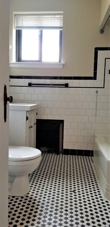 14 Ashland Street, Unit 2R Worcester, MA 01609 - Photo 10 of 16 a bathroom with a sink a toilet and a window