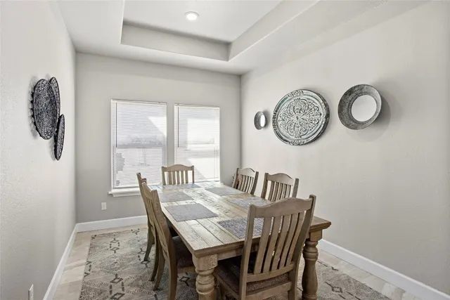 a view of a dining area with furniture and a large window