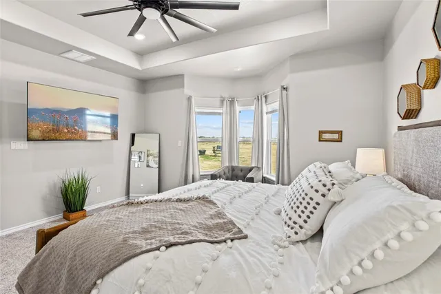a bedroom with a large bed and a chandelier
