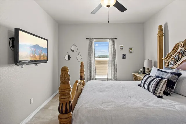 a bedroom with a bed and a flat screen tv