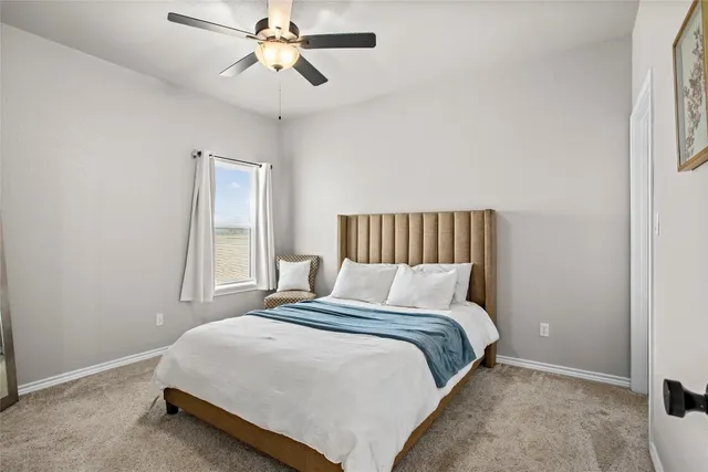 a bedroom with a bed and window