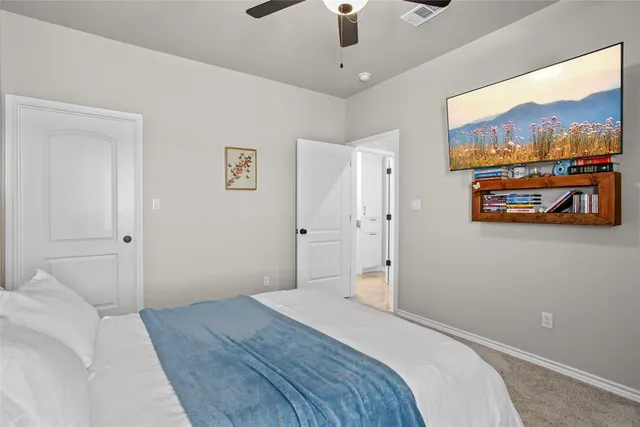 a bedroom with a bed and a painting on the wall