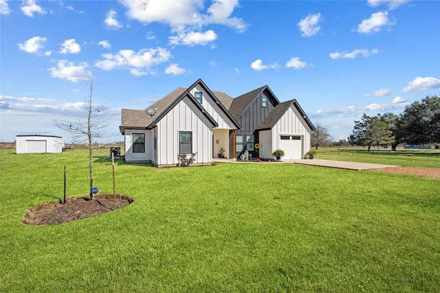 a view of a house with a yard and sitting area