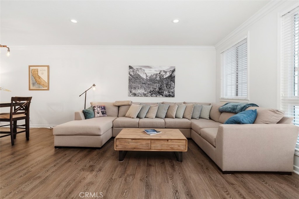 19451 Pompano Lane, Unit 110 Huntington Beach, CA 92648 - Photo 11 of 54 a living room with furniture and a wooden floor
