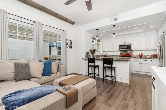 a kitchen with kitchen island granite countertop a sink cabinets and stainless steel appliances