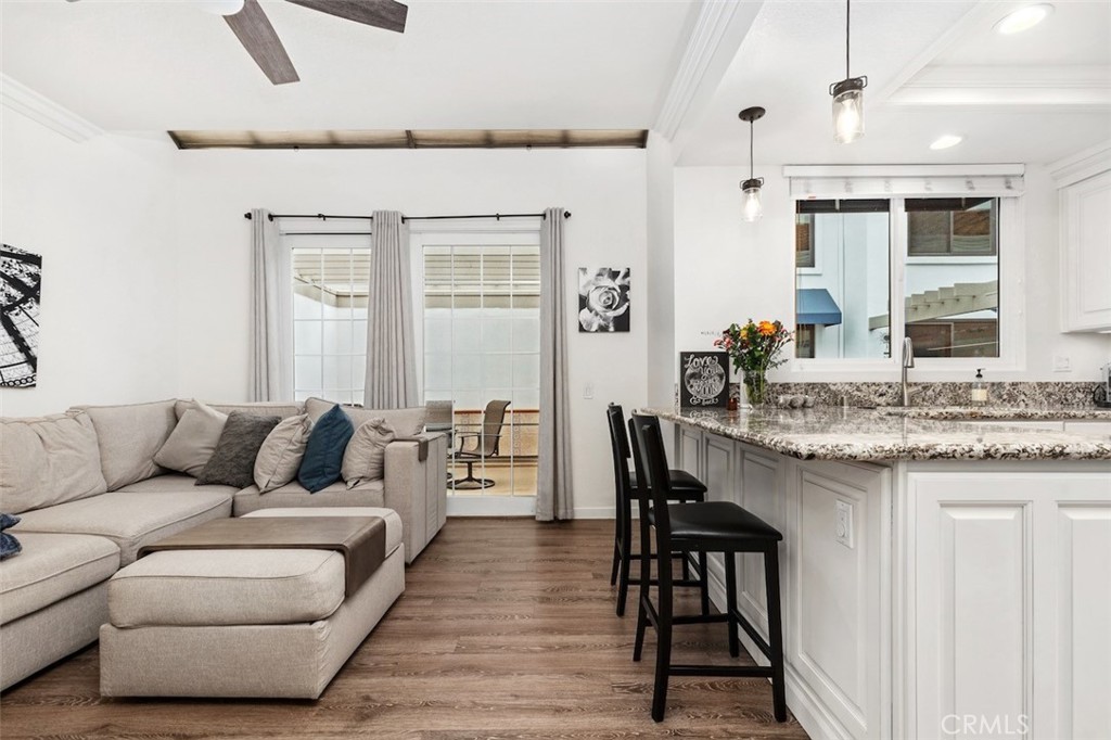 19451 Pompano Lane, Unit 110 Huntington Beach, CA 92648 - Photo 17 of 54 a living room with furniture and a wooden floor