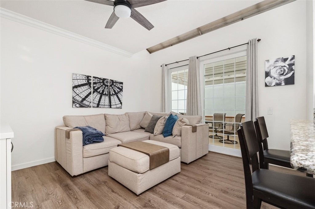19451 Pompano Lane, Unit 110 Huntington Beach, CA 92648 - Photo 19 of 54 a living room with furniture and wooden floor