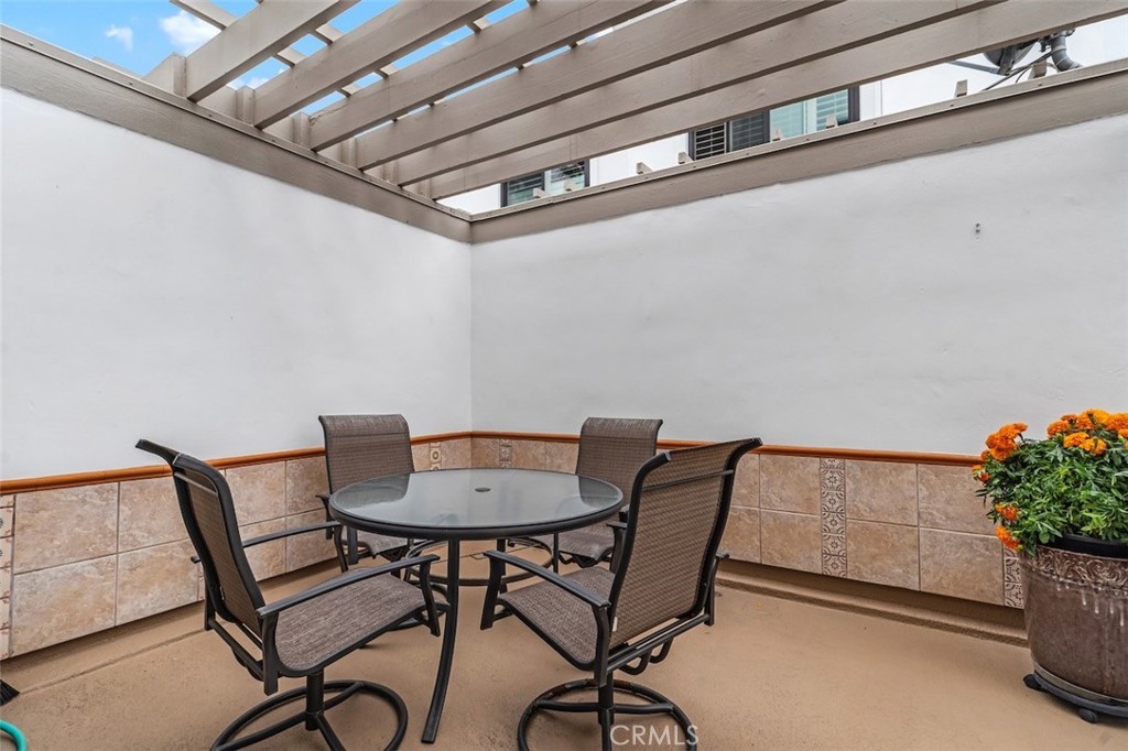 19451 Pompano Lane, Unit 110 Huntington Beach, CA 92648 - Photo 20 of 54 a view of a dining room with furniture and wooden floor
