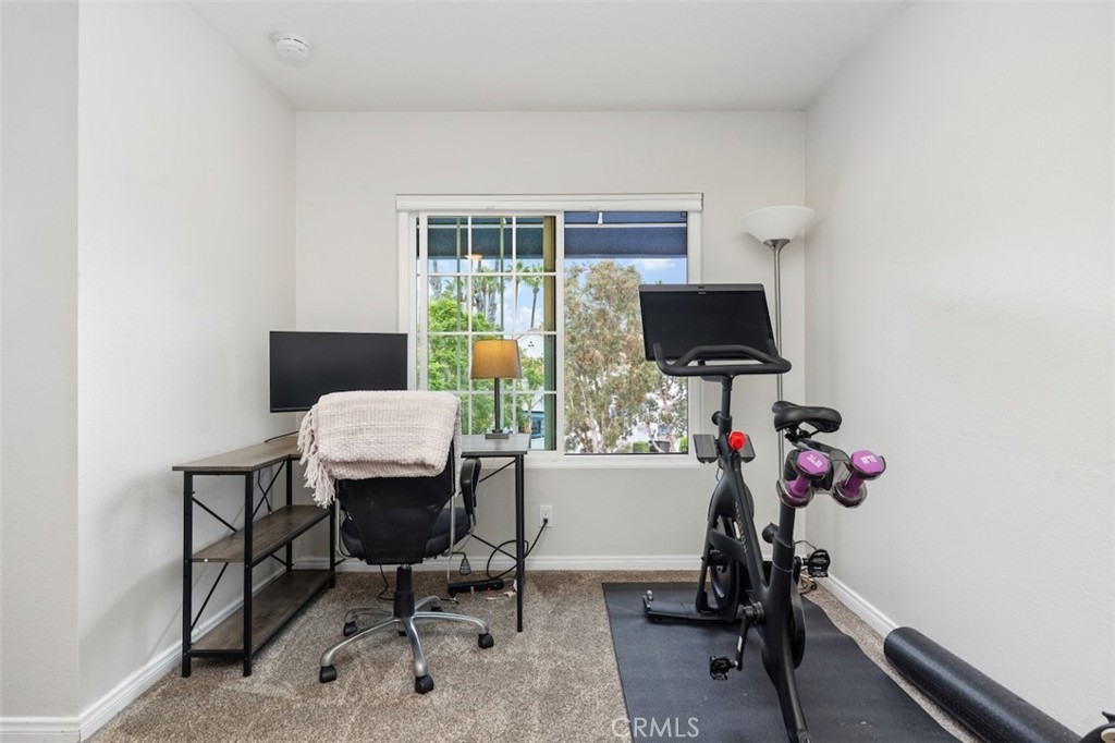 19451 Pompano Lane, Unit 110 Huntington Beach, CA 92648 - Photo 23 of 54 a view of a workspace with furniture and a window