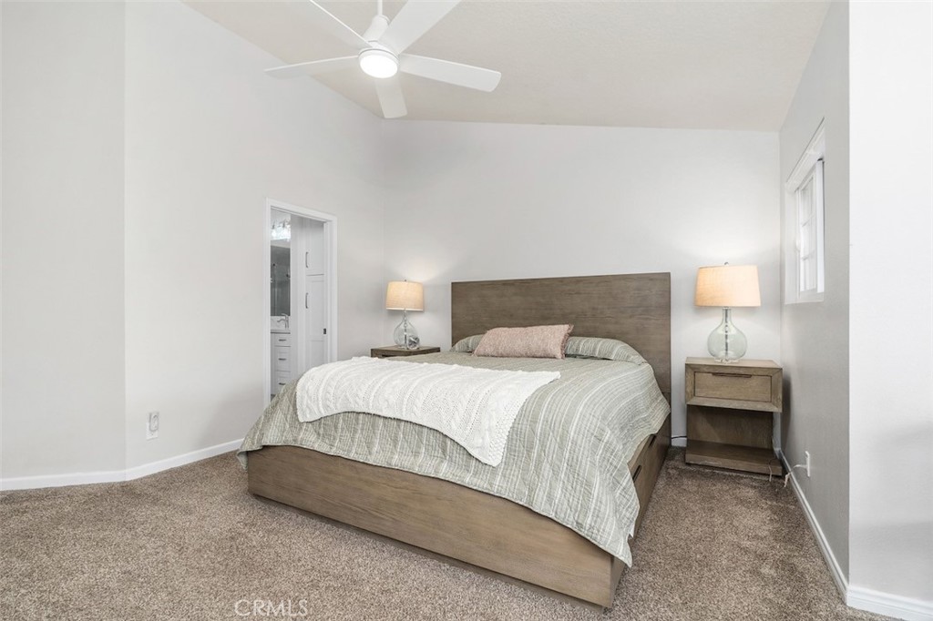 19451 Pompano Lane, Unit 110 Huntington Beach, CA 92648 - Photo 24 of 54 a bedroom with a bed and a ceiling fan