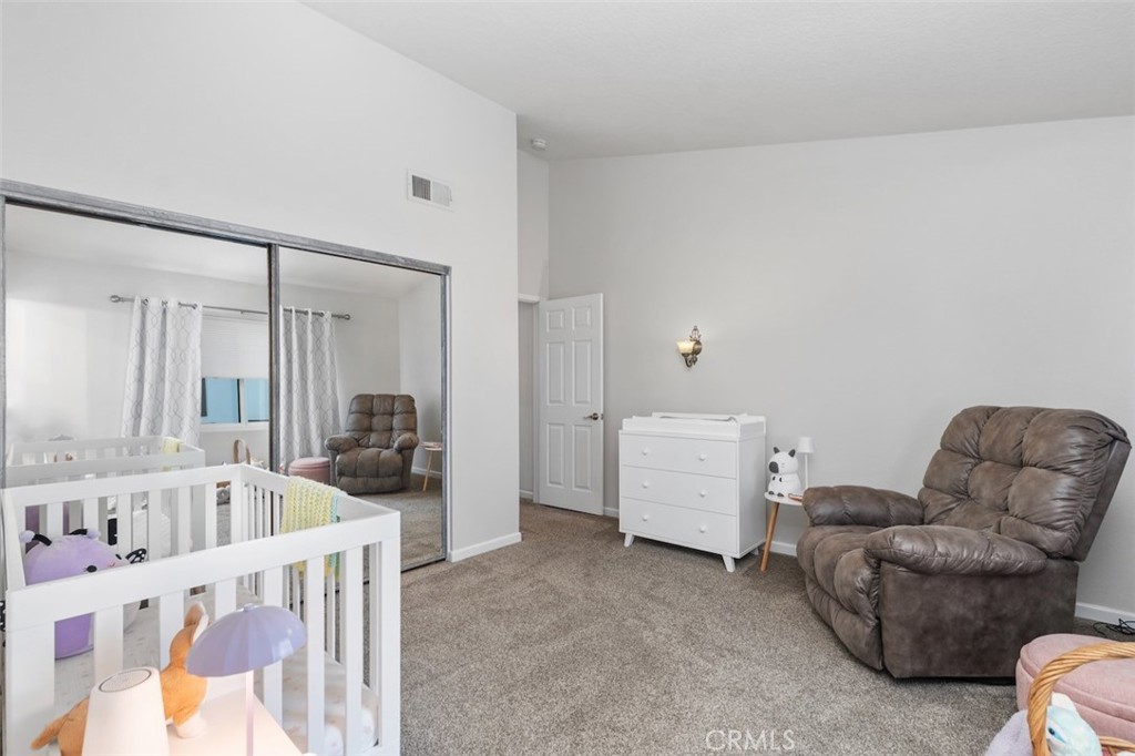 19451 Pompano Lane, Unit 110 Huntington Beach, CA 92648 - Photo 31 of 54 a living room with furniture and a large window