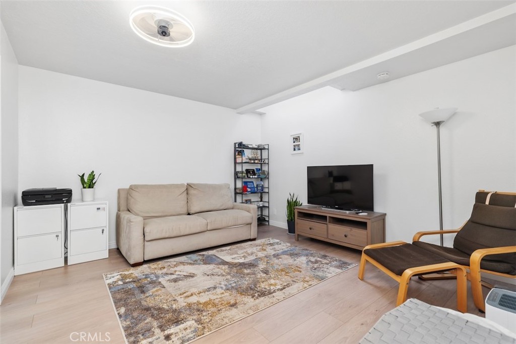 19451 Pompano Lane, Unit 110 Huntington Beach, CA 92648 - Photo 34 of 54 a living room with furniture and a flat screen tv