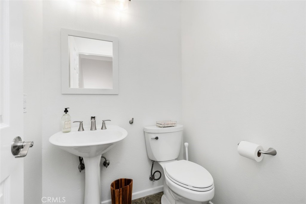 19451 Pompano Lane, Unit 110 Huntington Beach, CA 92648 - Photo 37 of 54 a bathroom with a sink a toilet and mirror