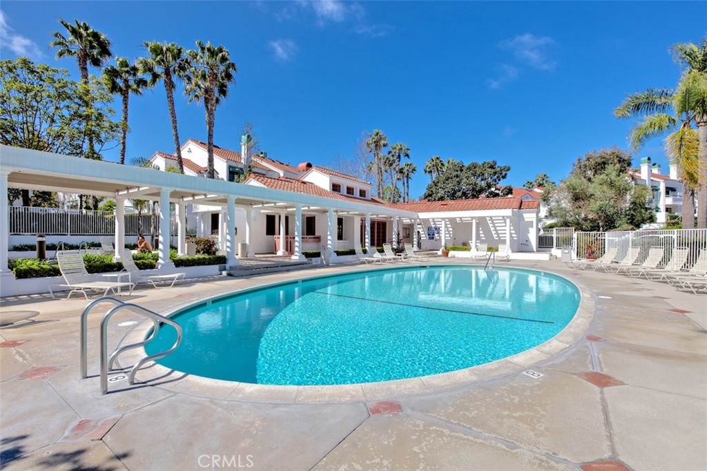 19451 Pompano Lane, Unit 110 Huntington Beach, CA 92648 - Photo 45 of 54 a view of a house with swimming pool