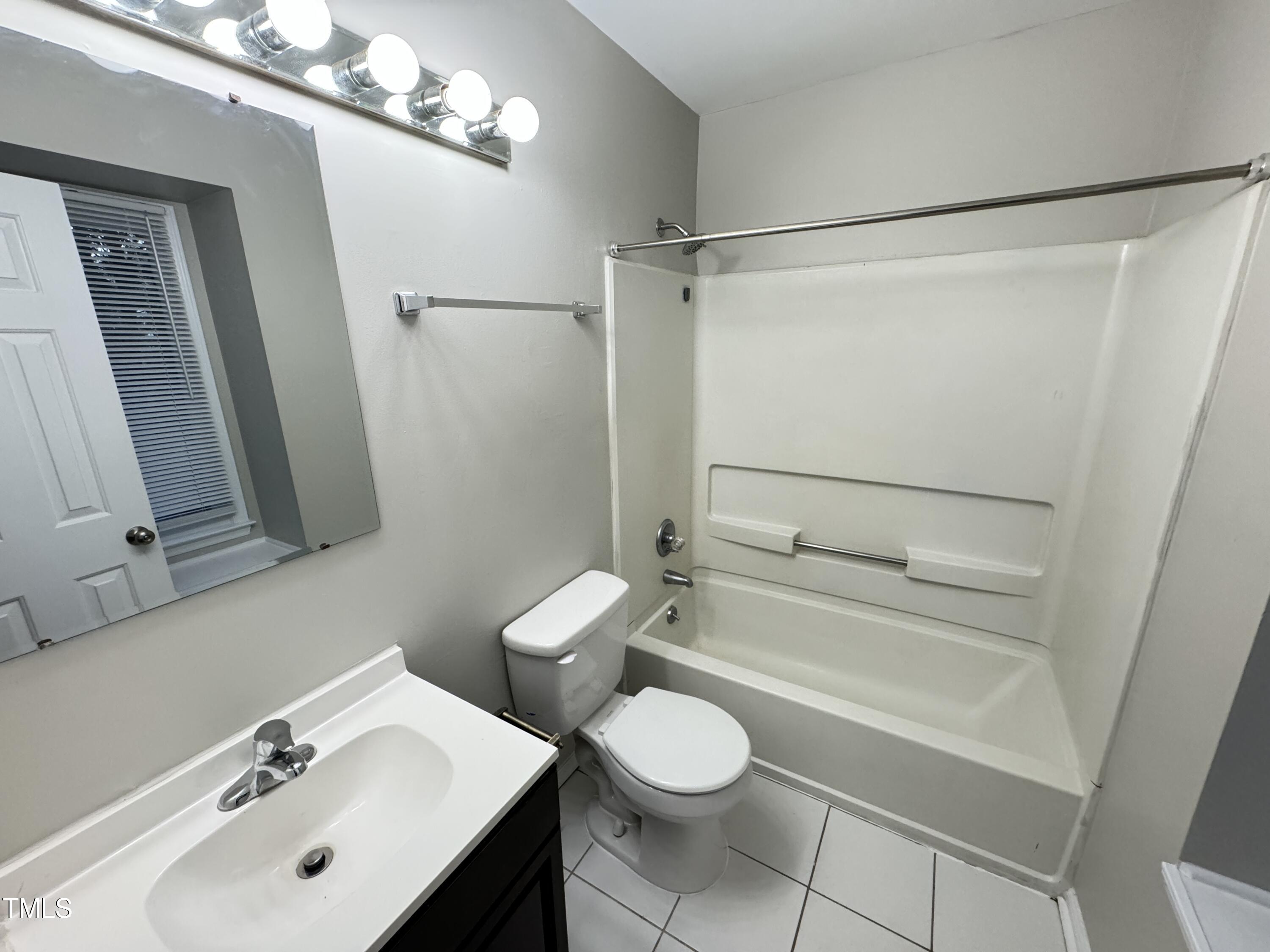 456 Dickens Drive Raleigh, NC 27610 - Photo 19 of 33 a bathroom with a sink mirror vanity and toilet