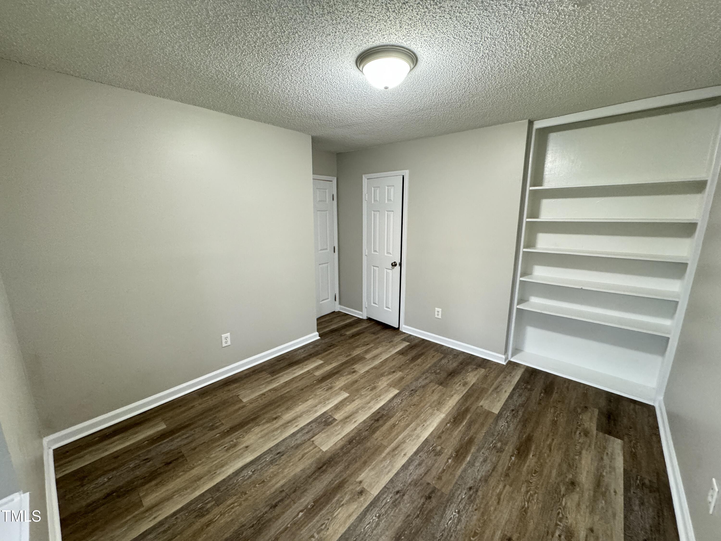 456 Dickens Drive Raleigh, NC 27610 - Photo 24 of 33 a view of room with stairs and wooden floor