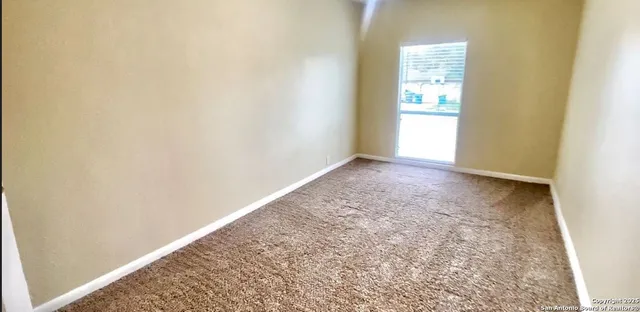 a view of an empty room and a window