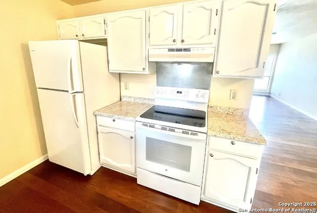 a kitchen with a stove a refrigerator and a stove
