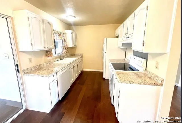 a kitchen with a sink stove and a refrigerator